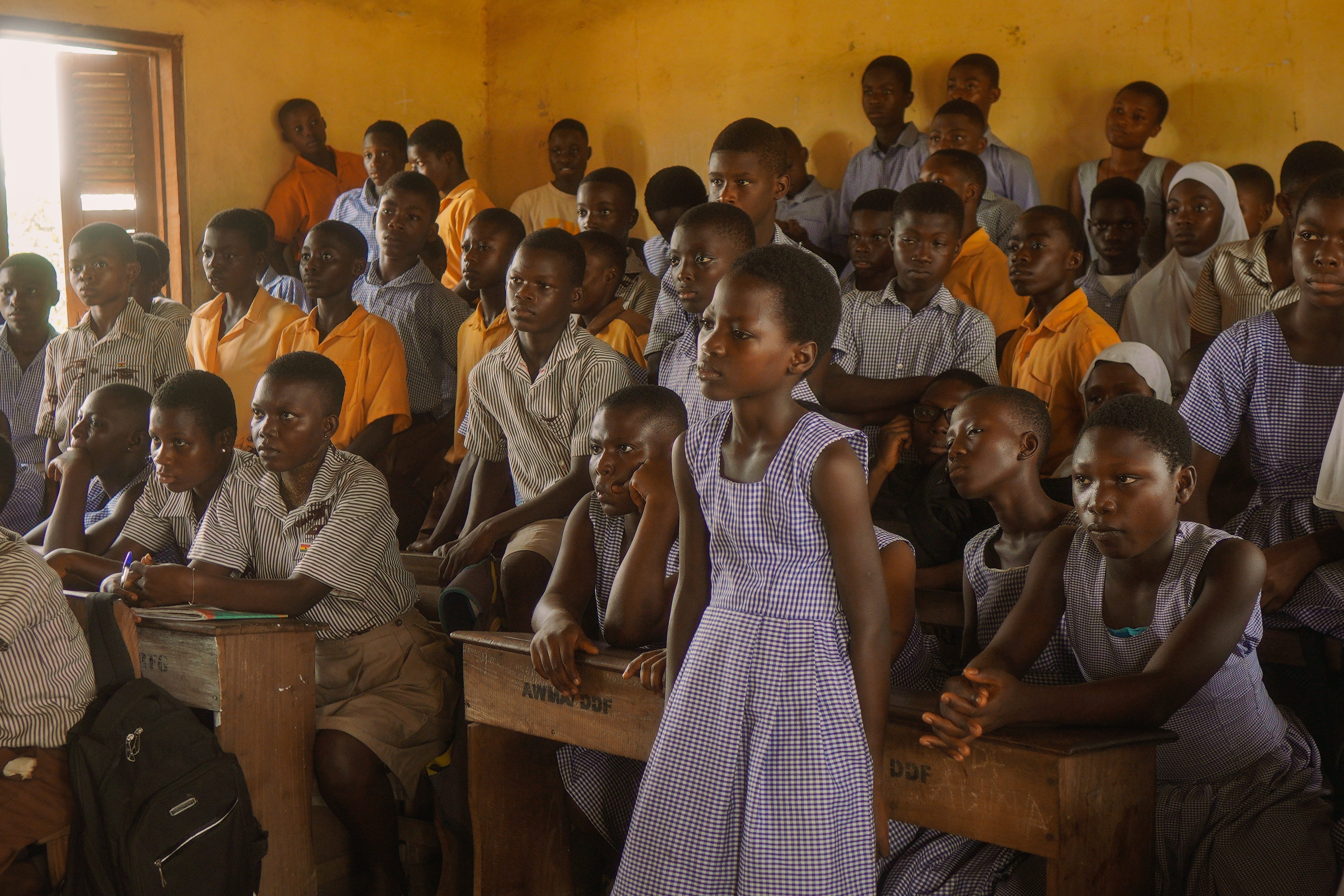 Three girls reading books in the AAAGML library